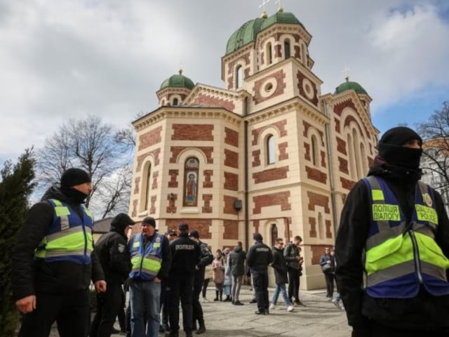 ukrainian police officers stand next to st george s cathedral of the ukrainian orthodox church accused of being linked to moscow amid russia s attack on ukraine in lviv ukraine april 5 2023 photo reuters